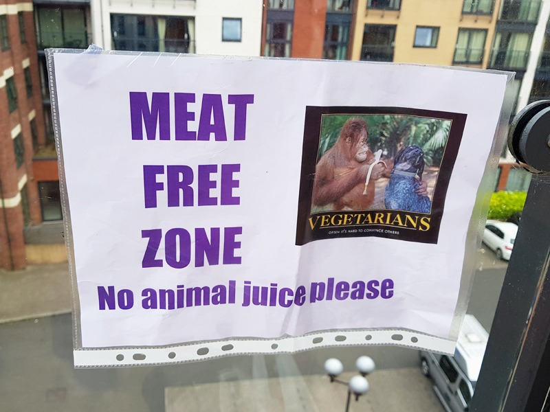 A sign at a BBQ which reads "Meat Free Zone, no animal juice please"