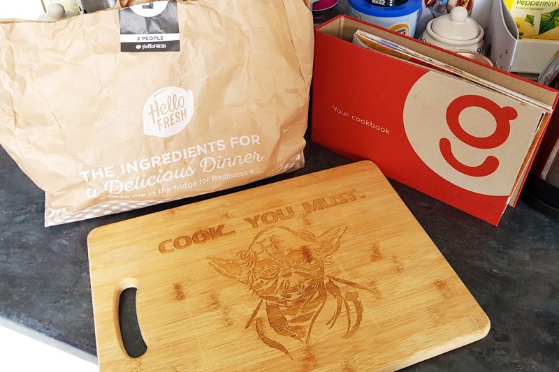 A Hello Fresh recipe bag and Gousto cookbook sat behind a Yoda Star Wars chopping board