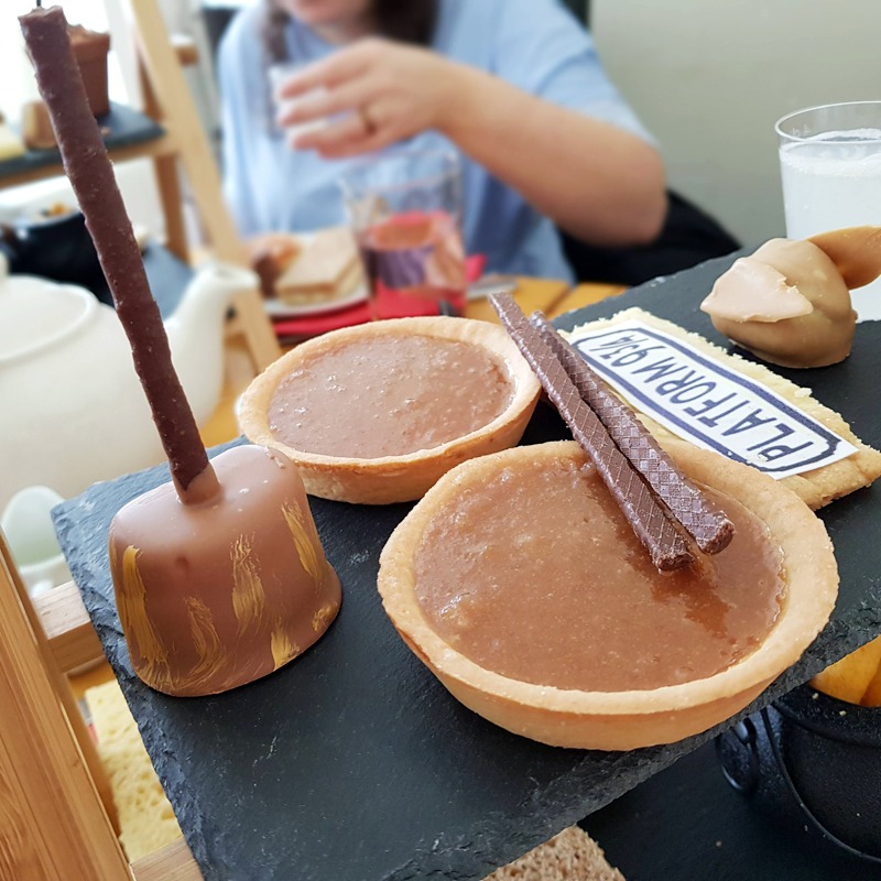 A close-up of the Harry Potter Afternoon tea, showing the treacle tarts and chocolate-covered marshmallow broomsticks